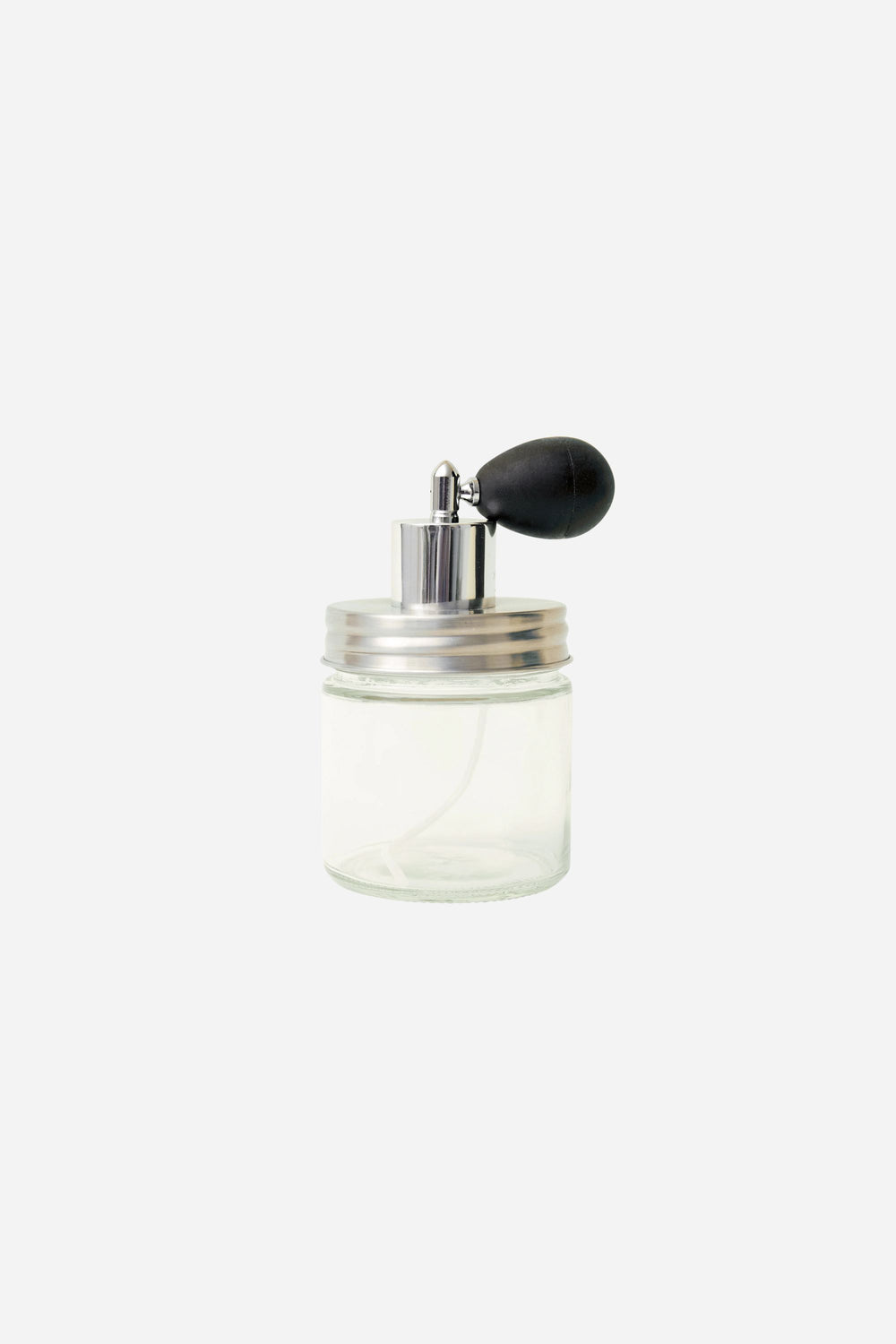 Clear glass perfume jar with black top on a white background